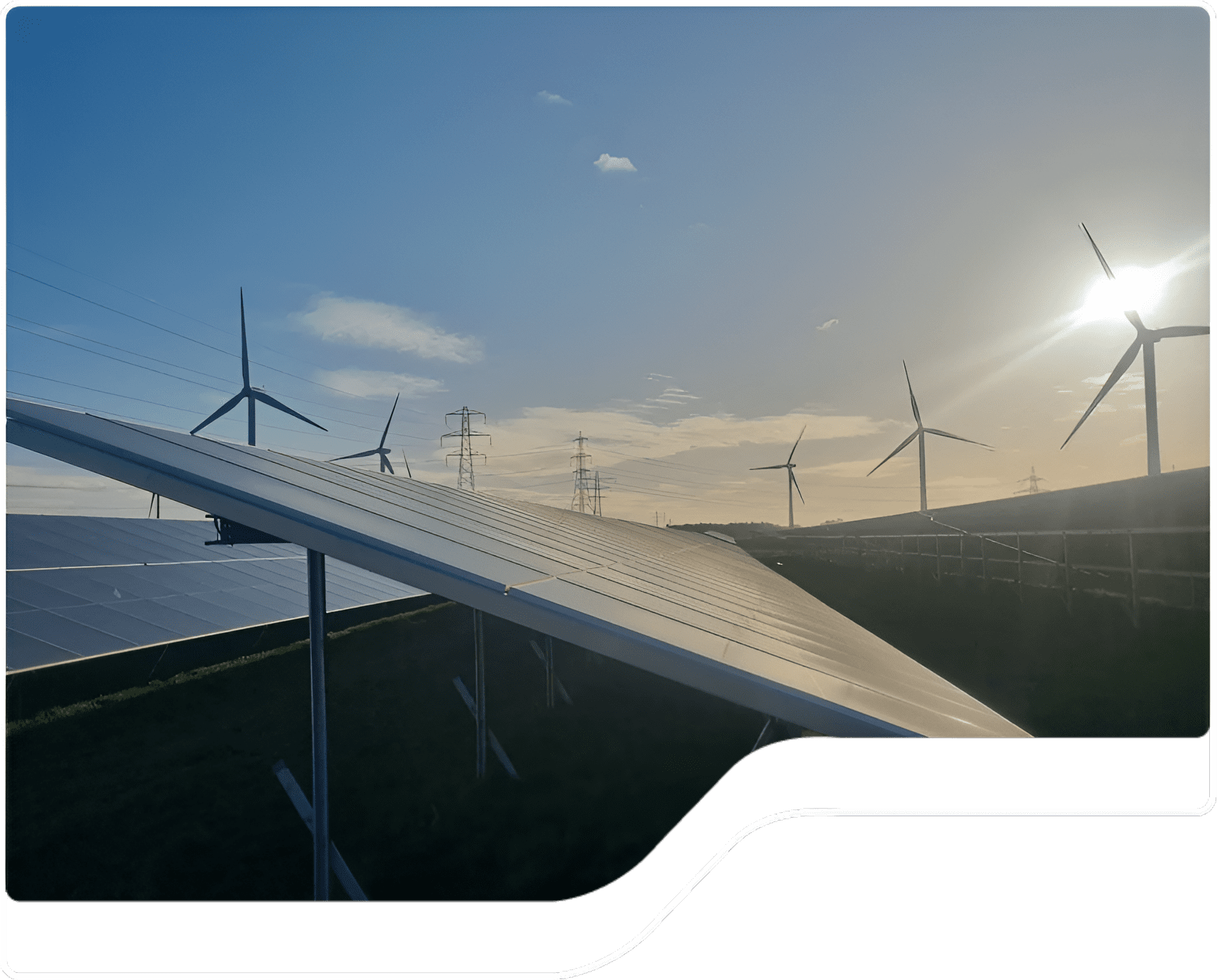 Group 1321314614 Solar panels and wind turbines at sunset.